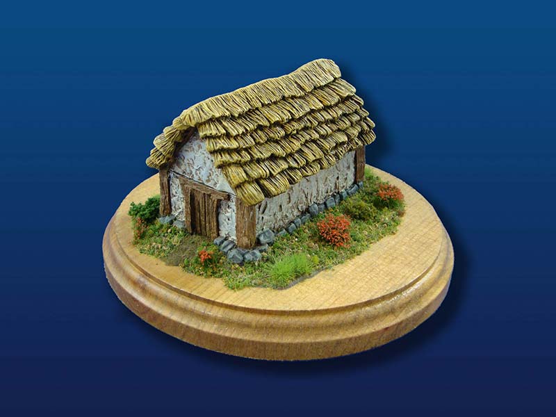 Small daub and timber barn with thatched roof.